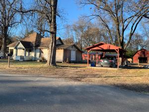 Seller has reduced the sales price to offset the cost of some of the repairs. The new owner will own the entire Block.  Buyer could have a new roof, new windows and new siding all the way around the house for under 10k per estimate provided to seller.Nice Barn with Stalls that could easily be converted to a shop!Seller has done most of the hard work.All thats left is to move in and finish it up and reap the rewards!!Seller has updated plumbing, electrical, faucets,tub,shower,commode,sheetrock,flooring, hot water heater and more. No Restrictions!