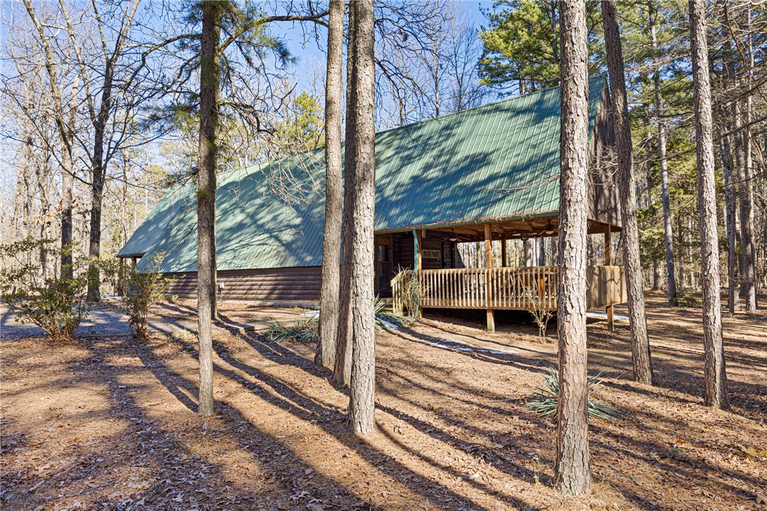 Tucked away on 4 wooded acres atop Petit Jean Mountain—less than 2 minutes from Petit Jean State Park—this A-frame cabin, Moosehead Cabin, feels like an escape the moment you arrive.
Designed for quiet mornings and late nights, the home features an extended covered front porch that’s perfect for hosting friends or simply unwinding while listening to the whippoorwills roll in at dusk. As the sun sets, soft pathway lighting guides you from the fire pit back to the porch, creating a warm, inviting atmosphere for evenings you won’t want to end.
Inside, you’ll find over 1,600 sq ft of comfortable, welcoming space. A gas fireplace anchors the living area, with the signature moose above it adding character and charm. Two spacious bedrooms and an oversized loft provide plenty of room for family, guests, or a relaxing weekend retreat.
A large shop offers additional space for projects or storage. This isn’t just a house—it’s a place to slow down, spread out, and enjoy life near one of Arkansas’ most iconic destinations.