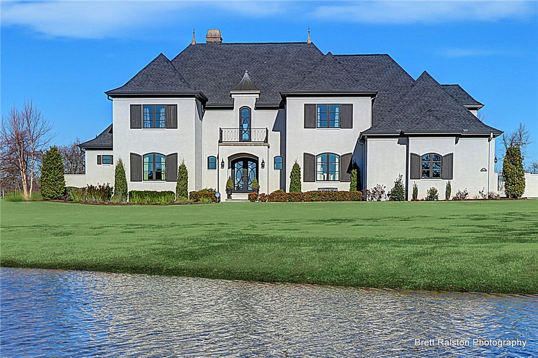 Stunningly beautiful home w/exquisite attention to details. Soaring ceiling & fabulous crystal pendant chandelier in living room that overlooks backyard made for entertaining . Large kitchen w/Carrera marble countertops, huge island seats 8, gas cooktop, double ovens, built-in refrigerator.  Main level features LR, KIT, FDR, OFF, & luxurious master bedroom & bath.  Upstairs features 3 br's, 3 ba's & over 500 sf of unfinished space. Sports pool w/spa, outdoor living w/FP & automated screens.
