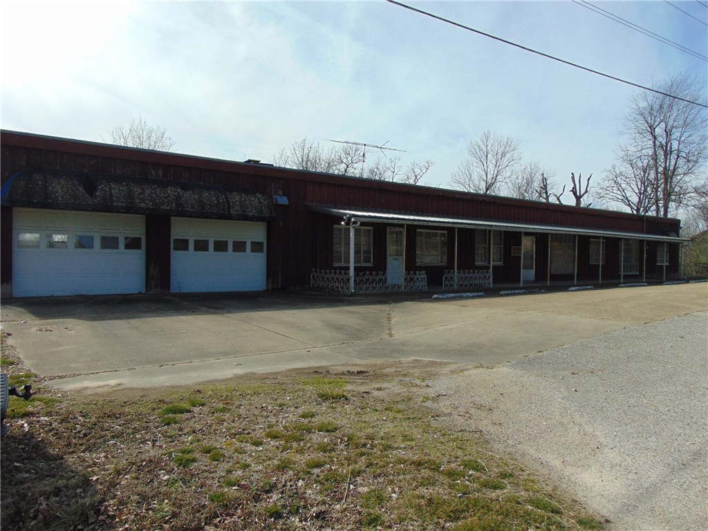 Large 3 bed, 2 bath home outside city limits. Land goes to nice river view.  Several outbuildings on property.  Once used as living quarters and commercial art retail property.  Could be purchased as house with extra bedroom or another commercial operation.