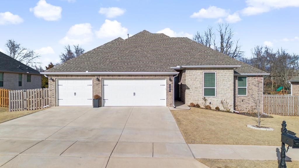 Lovely, well-maintained home in the desirable Arlington Subdivision, located in the Pea Ridge School District. This split floor plan offers comfort and privacy, accented by stained wood beams, crown molding, and a cozy gas fireplace with shiplap detail. The kitchen features granite countertops and opens seamlessly to the main living areas. The spacious primary suite includes a jetted tub and a tiled walk-in shower. With two full bathrooms and an additional half bath, there’s room for everyone. Enjoy outdoor living on the well-designed covered patio overlooking a fully fenced yard with a 20' x 20' raised bed garden—ideal for relaxing or entertaining.