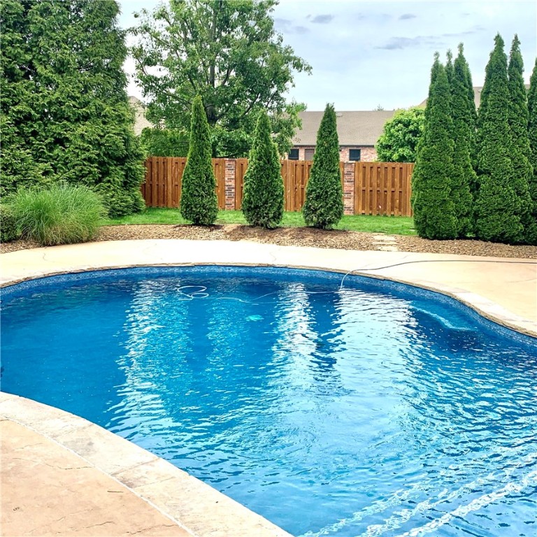 Entertain in style at your own private resort. Breathtaking pool w/tanning shelf & poolside cabana  offering a kitchen, bar seating, Fireplace, outdoor shower & pool bathroom. Additional covered grilling patio & multiple outdoor dining areas outlined by private lush grounds. Generous floor plan offering luxurious Owner suite w/private patio & Guest en-suite on main level. Formal & casual living spaces, guest half bath plus handsome study w/fireplace & built ins. Chef's kitchen w/island & prep sink, gas range, double ovens, walk in pantry, built in wine, china & desk cabinetry open to both living spaces. Second level features bonus area, 2 guest rooms w/jack & jill bath & walk in closets plus 5th bedroom/nursery/exercise room. Fabulous 3 car garage w/professional cabinetry & epoxy flooring. Few updates include: Roof/Gutters, new pool gunite & mosaic tiles, interior & exterior paint, fixtures, flooring, custom designed owners closet & more. Located in gated Pinnacle Country Club.