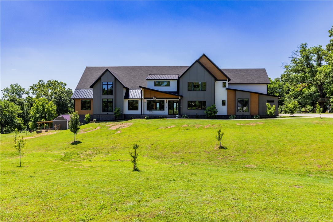 Welcome to luxury estate living in the prestigious Little Osage Hills, one of Northwest Arkansas' most beautiful and sought-after estate communities. Nestled on more than 4 private acres with direct access to Little Osage Creek, this exceptional estate offers nearly 6,800 square feet of thoughtfully designed living space. Featuring 7 bedrooms, 6.5 bathrooms, and an expansive floor plan, this home provides endless possibilities for comfortable living and entertaining. The fully finished basement offers the potential for separate living quarters. Outside, enjoy resort-style amenities including a stunning infinity-edge pool, hot tub, and plenty of room to experience the natural beauty of the Ozarks. The Little Osage Creek winds through the eastern side of the neighborhood, creating a peaceful and picturesque setting that feels worlds away, yet remains conveniently close to everything N.W. Arkansas has to offer. Located just 18 minutes from the Pinnacle Hills area where premier dining, shopping, and entertainment live.