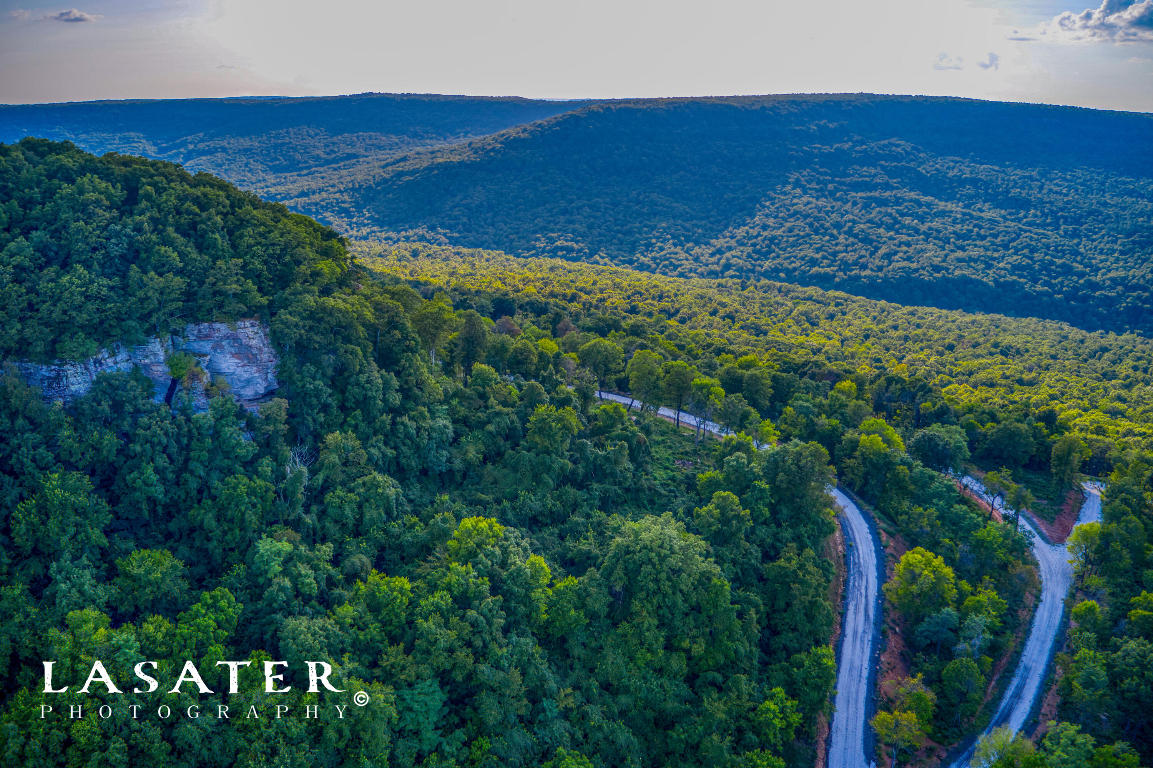 Surrounded by over 4,000 acres in the beautiful Ozark Mountains, Round Mountain Estates features lots with wide ranging rock formations, natural springs, beautiful bluffs, and unforgettable views. All lots are designed to embrace the Ozarks' natural terrain and vistas. Whether you're seeking a second home, an investment opportunity, or a full-time residence, Round Mountain Estates will accommodate custom homes 2,500 square feet up to the square footage you desire. Enjoy the common area with over 300 acres featuring a year round stream, several ponds, and incredible bluffs to climb with views that are sure to leave you speechless. Amenities coming soon including hiking/biking/utv trails and a community pool. Lot 65 is .9 acres. www.roundmountainestates.net