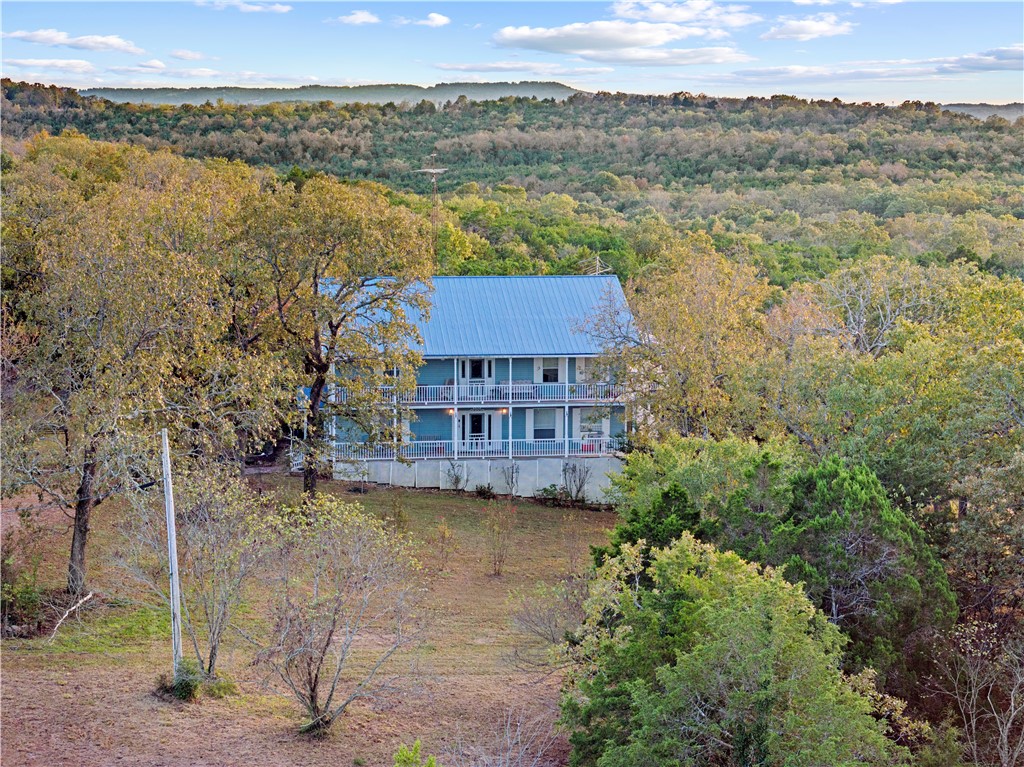 Welcome to your Ozark getaway just minutes from the Peel Ferry connecting you to the resort-style living of Bull Shoals Lake. This expansive home boasts over 5,000 sq ft of space, featuring 5 generously sized bedrooms, 2.5 baths, and an open-concept layout anchored by a large gourmet kitchen that’s perfect for entertaining or everyday family living. Vaulted ceilings, wrap-around deck areas, and wooded mountain views set the stage for outdoor adventure and peaceful retreat. Located in the Woods Cove community, you’re close to lake access, hiking trails, and the beauty of northern Arkansas — yet just a comfortable drive to Harrison for everyday conveniences. Perched across the cove from Hwy 125 Boat Dock, this property offers convenient access to all the wonders Bull Shoals Lake has to offer!