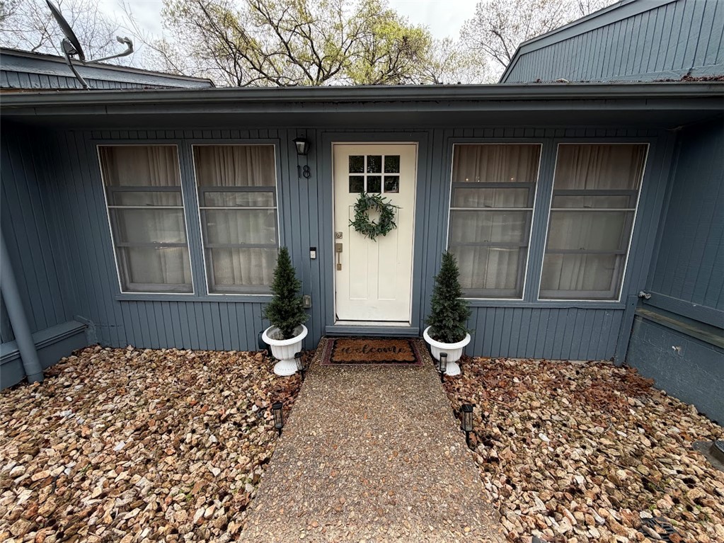 Charming townhouse in beautiful Bella Vista! This property features a small living area upstairs and a bedroom with private balcony with a gorgeous wooded view. The bedroom upstairs has a Jack and Jill bathroom that cuts through to the laundry area. Downstairs features two bedrooms, a bathroom, a wood burning fireplace and a small deck area out the back door. The downstairs area could also be used as another living area, office or exercise room. This property would make a perfect starter home or investment property for short or a long term rental. This Property is close to all the creeks and bike trails and everything Bella Vista has to offer! Bentonville School district and approximately 10 miles to Walmart home office.