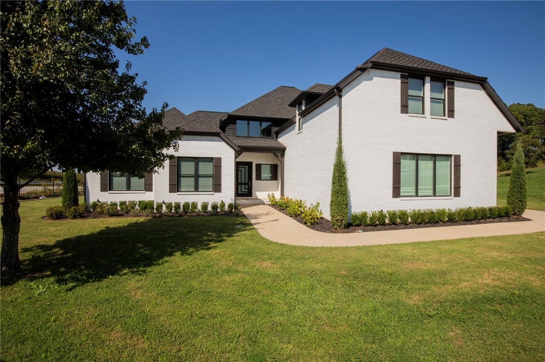 Stunning home with a modern open floor plan, designer finishes, and flexible living spaces in one of Rogers’ most sought-after communities, plus in Bentonville School District.  Chef-designed gourmet kitchen features professional Frigidaire built-in refrigerator/freezer and DCS by Fisher & Paykel range and hood. Offering 4 bedrooms plus bonus/flex room ideal for a 5th bedroom, media room, or office. Main level includes 2 bedrooms, dedicated office, dining area, oversized laundry, and 2 fireplaces. Spacious primary suite with heated tile shower floors. Hardwood flooring throughout main level, staircase, and upstairs hall. Enjoy outdoor living on the covered deck with fireplace and convenient rear gate access. Located in the Bentonville School District near Pinnacle amenities, shopping, dining, Mercy, Walmart AMP, Topgolf, and I-49.