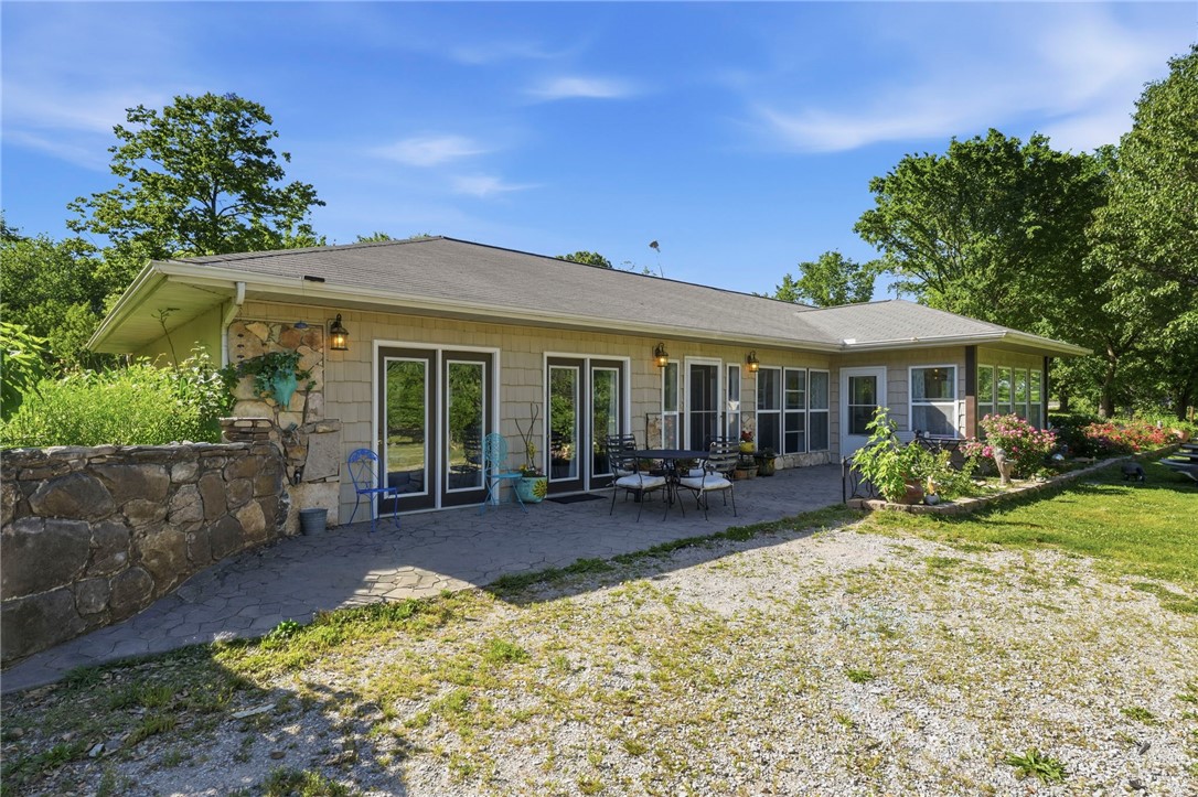 Home & 5 acres located outside city limits offering privacy, flexibility, and investment potential. Property features a 3 bedroom, 2 full bath home with 2 living areas, gorgeous windows, French doors, a sunroom, and a large front patio perfect for relaxing or entertaining. The property also includes a large 20x100 shop with water, electric, bathroom, and multiple garage doors. Plus there are multiple carports on site. Extra separate septic and electric meter are already in place for another home site, creating potential for an additional residence, rental setup, or future lot split.

There are an abundance of fruit trees on the property add to the peaceful setting and make this a place you can truly enjoy. No restrictions! This could be a multi generational compound or bring your animals for a small hobby farm. Great opportunity for someone needing room for equipment, hobbies, or business use!
