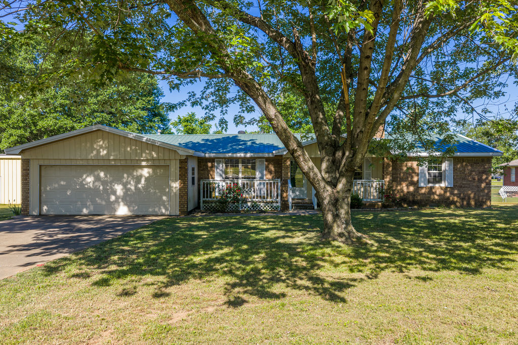Spacious home in need of TLC & updating! 3 bedroom 2 bath with a bonus room. Newer metal roof, covered deck, fenced back yard, oversize 2 car garage, WB fireplace. Close to I-40 & I-49 access, restaurants, doctors, schools, churches, fire station. Being sold AS IS.