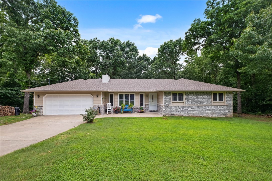 Discover the perfect blend of comfort, nature, and recreation in this inviting Bella Vista home. Nestled on a gently sloping corner lot surrounded by mature trees, this 3-bedroom, 2-bath home offers the peaceful setting you've been searching for. Inside, you'll find an open, welcoming layout featuring updated flooring, tile, lighting, quartz countertops, and appliances, creating a stylish, move-in-ready space. The sunroom is the perfect place to enjoy your morning coffee or unwind with a good book, while the spacious back deck invites you to relax, entertain, or take in the tranquil wooded views. Living in Bella Vista means more than owning a home—it's embracing a lifestyle with access to scenic lakes, championship golf courses, miles of walking and biking trails, parks, recreation centers, and endless opportunities to enjoy the outdoors. Conveniently located just minutes from Bentonville, you'll experience the best of Northwest Arkansas while coming home to your own peaceful retreat.