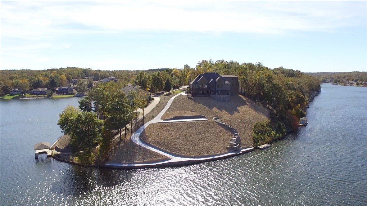 Experience the most breathtaking views from this brand new lakefront home. Built by OAK Homes, this incredible estate sits on over an acre above beautiful Lake Loch Lomond. Enjoy boating, fishing, skiing or take a quiet cruise over to the marina where you can dine at Lakepoint Restaurant. This home captures true lake living at its best. The main living room boast floor to ceiling windows & a 20 foot stack stone fireplace. The gourmet kitchen features top of the line appliances package and walk-in pantry.