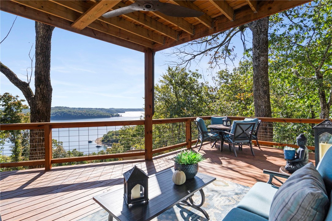 Experience the beauty of lake living in this stunning home overlooking the sparkling waters of Beaver Lake with private dock (11x30 slip). Designed to capture breathtaking views from every room, this property offers the perfect balance of comfort, style, & serenity. Step inside to a spacious open concept living areas, large windows flood the home with natural light, & a modern kitchen with high-end appliances & finishes, perfect for entertaining. The primary suite features a deck with panoramic lake views, creating a peaceful retreat after a long day on the water. Outside enjoy the expansive decks and outdoor living spaces, ideal for morning coffee or evening sunsets. With easy access to the lake, nearby Lost Bridge Marina, & miles of scenic shoreline...this home offers an ultimate lifestyle, furniture is negotiable A charming Casita completes this property, ideal for hosting visitors! Includes a gym, 2 bedrooms, & full bath. Large storage facility behind Casita for water toys.  Schedule your showing today!