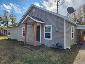 Close to the University of the Ozarks, this 3 bed 2 bath home, Has brand new siding and new windows, newer flooring with recently painted rooms, Large fenced back yard with small shed.  Carport with mud/ utility room . Roof is in great shape and not very old.   Big fenced back yard makes this a great family home.