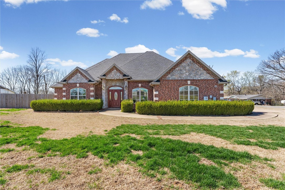 Welcome to 200 W Kimberly Lane in Rogers! Situated on a spacious 0.59-acre cleared corner lot, this property offers plenty of room to enjoy both indoor comfort & outdoor living. Inside, the home features a bright eat-in kitchen along with a separate dining area, providing flexible space for everyday meals or entertaining guests. The living room is anchored by a cozy fireplace & accented with elegant crown molding. The primary suite includes a relaxing retreat with a soaking tub & separate shower, perfect for unwinding at the end of the day. Step outside to the covered patio, ideal for outdoor dining, gatherings, or simply enjoying the peaceful surroundings of this generously sized lot. With its desirable corner location & spacious yard, this Rogers home offers comfort, style, & room to make it your own!