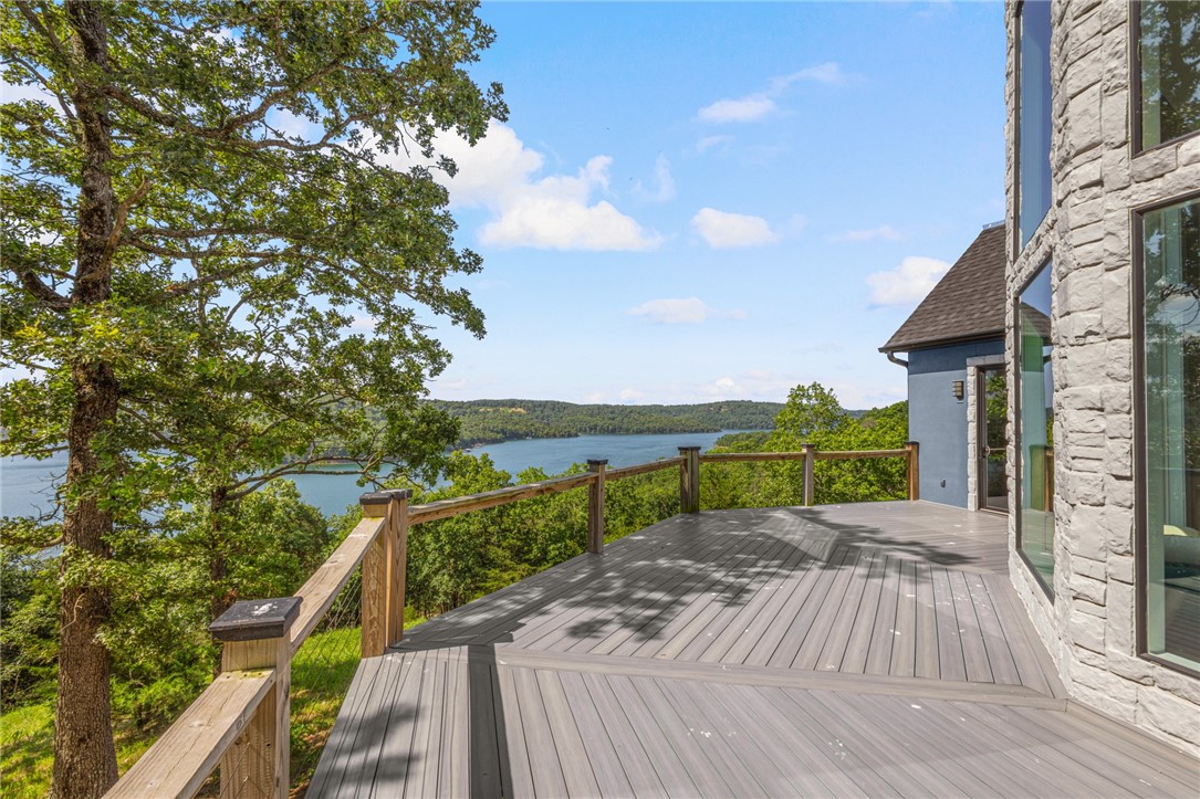 "$6,000 In Prefered Lender Credit!" Just in time for the heat of summer!  Walk right in & unpack your bags & enjoy the 180 degree view of Beaver Lake w/floor to ceiling windows along the back of the house.  The choice is yours, to step out on the brand new trek deck and enjoy the view or take the 5 min drive to the community boat slip and hop in your new 2012 Cobalt 232 and go out on the lake.  This completely remodeled, 3 bdrm, 2.5 bath home plus bonus comes completely furnished w/everything you need to enjoy all things lake, right down to the slip, boat and lift plus 2 car garage attached and an additional garage underneath for a side-by-side and all lake toys.  This home is one you don't want to miss!