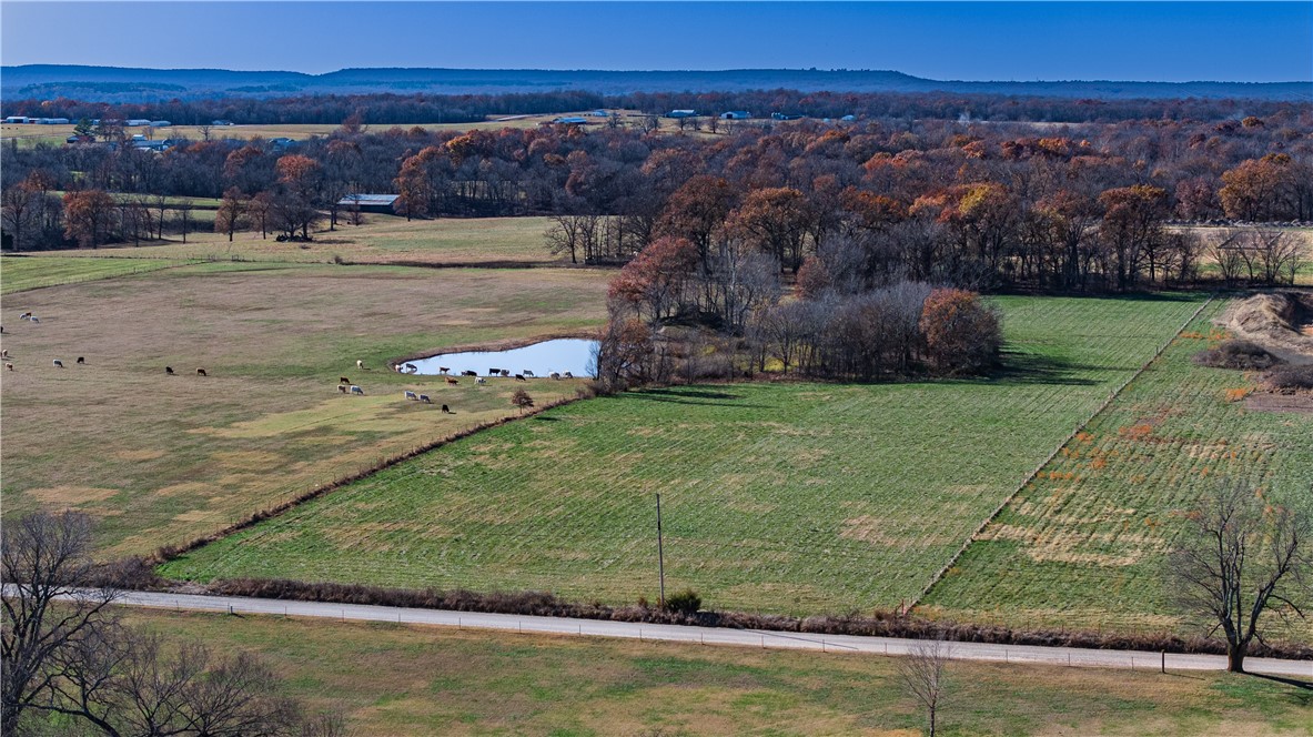 Build your estate home on 7.375 acres minutes from town. First time on the market in over 75 years.  Fully fenced with survey. No deed restrictions. Rural water tap available. Ozarks Go and Ozarks Electric at the street, plus natural gas. Located near the corner of White Oak Rd. and Harmon Rd.