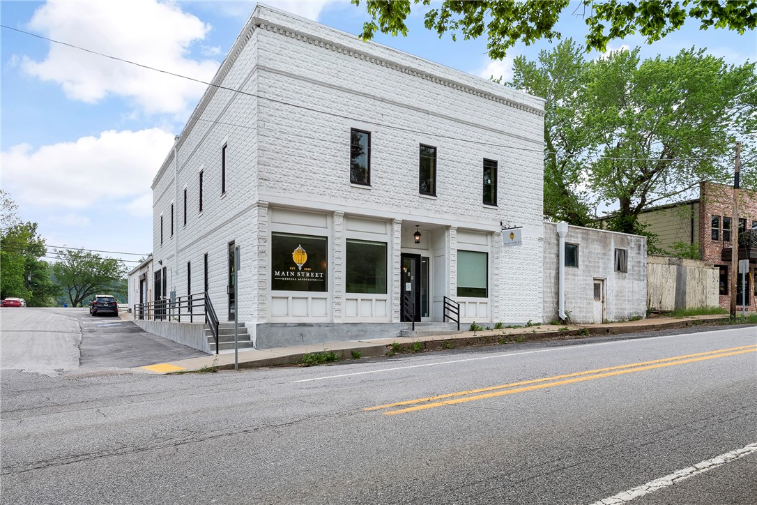Once in a lifetime opportunity! Here is your chance to own one of Downtown Cave Springs historic buildings before its revitalization & development! Right across the street from Cave Springs Park, Lake Keith, & Illinois River Watershed. Minutes from XNA Airport, Promenade Mall, Walmart AMP, Top Golf, & much more. Get ahead of the development in Cave Springs with an investment in a piece of its history. Property features 3 spaces totaling 11,915 s.f.  Newly remodeled office currently used as a medical practice (3,200 sq ft), unfinished upstairs space with original 1914 hardwood floors ready to be converted into your vision (3,200 sq ft), & 5,515 s.f. of warehouse space that would make a perfect restaurant, brewery, coffee shop, etc. Warehouse space could be split up to make 4 spaces total. Property comes with green space right outside warehouse for outdoor seating area. New roof has been installed & each space has been re-wired & rough plumbed. Property can be listed on historic registry. Call for private tour today!