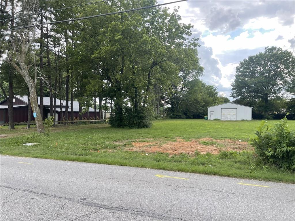 Exceptional commercial development opportunity in the heart of Centerton! This rare 0.73-acre level commercial lot is ideally situated just one block off Centerton Boulevard, offering outstanding visibility, easy access, and a prime location in one of Northwest Arkansas' fastest-growing communities. Zoned C-3 Commercial, this property provides excellent potential for a wide variety of commercial and business uses. The property also includes an approximately 1,500 sq. ft. workshop building ideal for storage, office space, contractor use, or support during future development. With its level terrain, valuable existing improvements, and highly desirable location near major retail, restaurants, and residential growth, this property is a rare investment opportunity. Whether you're looking to develop now or hold for future appreciation, this versatile commercial property offers exceptional potential.