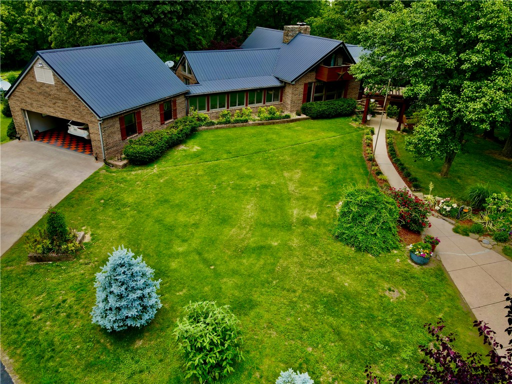 This 25+/- acre estate property has more to offer than almost imaginable and the landscaping is exquisite. It all begins with paved road frontage and a half mile private asphalt driveway. This amazing driveway meanders through flower filled pastures, majestic timber, and a stocked pond. Upon entering the property you're greeted by an 3129+/- sqft custom brick home with an attached 675+/- sqft garage. The main floor features a beautiful master bedroom with full bath, kitchen, bar, 2 guest bedrooms, 1 guest bath, open living room with floor-to-ceiling stone fireplace, and mud room. Upstairs you will find a relaxing loft area with a private balcony overlooking the mountains and beautifully landscaped grounds. The partial basement consists of a second attached garage, laundry, sauna, and storage space. Theres a large outdoor kitchen and expansive newer deck overlooking your private in ground pool. There's six additional outbuilding's totaling over 8300 SQFT, plus apartment equipped with heat, A/C, partial kitchen.