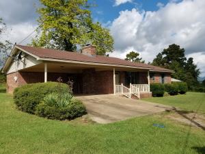 COZY AND COMFORTABLE.  This 3 bed, 2 bath is the perfect size for your family.  The living room has big windows with a great view and a large rock, wood burning fireplace!  The kitchen is spacious, open with an island and breakfast nook with lots of light.  With nice-sized bedrooms and large carport as well. Come see- this could be just what you're looking for!