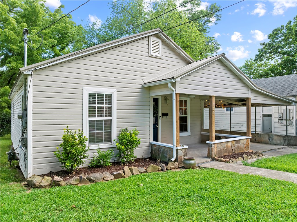 Conveniently located just minutes from shopping, dining, schools, and other Harrison amenities, this well-maintained 2-bedroom, 1.5-bath home offers 947 square feet of comfortable living space. The inviting interior features hardwood floors throughout most of the home, vaulted ceilings in the living room, and numerous updates completed within the last five years. The kitchen includes newer appliances, making it move-in ready for everyday living. Outside, the large backyard is shaded by mature trees, creating a private setting with plenty of room to relax, entertain, or enjoy outdoor activities. The metal roof, less than 8 years old, adds to the home's lasting value and low-maintenance appeal. Whether you're searching for your first home, looking to downsize, or simply wanting a well-cared-for property in a convenient location, this home offers comfort, quality, and thoughtful updates throughout.