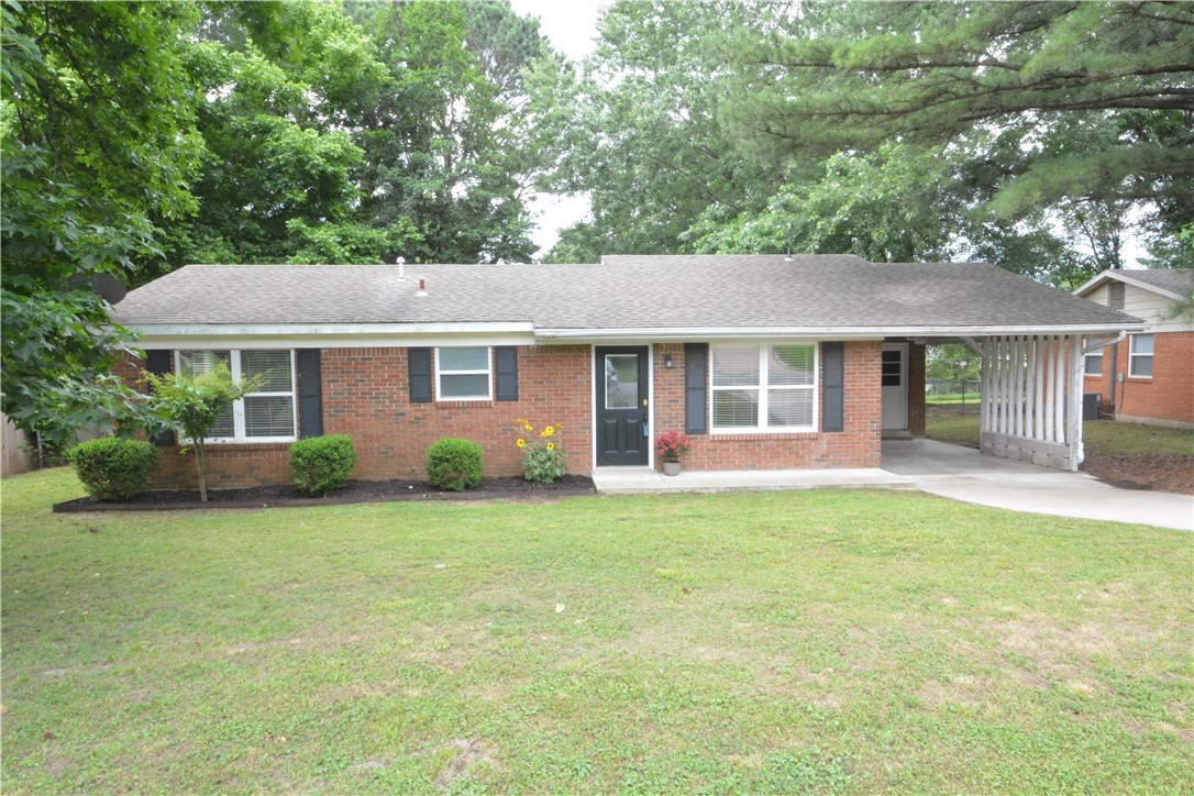 Enjoy this open floor plan just minutes from Tyson Corporate offices . Lots of remodeling in 2015, that included ceramic tile flooring through-out , new kitchen cabinet package , A/C unit , full & half bathrooms updated , new paint, lighting fixtures .  New bedroom carpeting has just been installed !  Nice large backyard with fully covered back patio .  Third bedroom area has been opened up for office/flex space .  Wood plank accent wall in living room  would make a great place for Electric Fireplace Unit !
