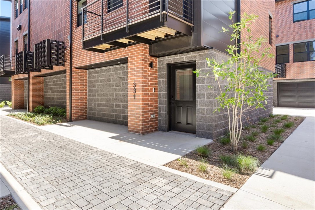 Located in downtown Bentonville's Arts District, 2BD/2.5BA + office condo offers unparalleled convenience! Walk or bike to the downtown square, Ledger, Crystal Bridges, The Momentary, 8th St Market, and the Wal-Mart campus. 2 car attached garage! Step inside to discover an open-concept layout with wood floors and a beautiful kitchen featuring quartz counters and custom soft-close cabinets. Each bedroom features walk-in closets and private baths. Outdoor balcony! Embrace the essence of modern living in NWA's most desired area!