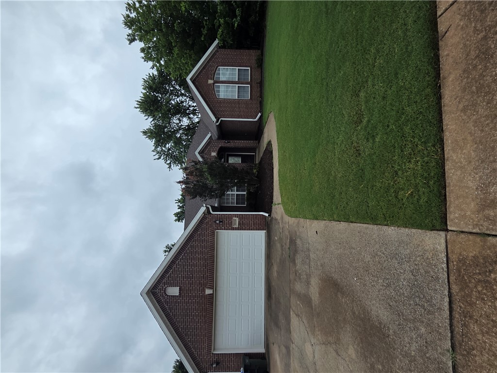 Spacious 4 BR, 2 ba house with a split floor plan. Eat-in kitchen plus a formal dining room. Wood floors in foyer, dining room, living room, and hall. Ceramic tile in utility room, kitchen, and baths. Covered patio, Privacy fenced back yard. Freshly painted + new carpet and wood flooring. Just a few blocks from Holcomb Elementary School and Holt Middle school. Less than 1 mile from I-49 and a short drive to U of A campus, grocery stores, a Sam's Club, restaurants, fitness clubs, and other shopping.