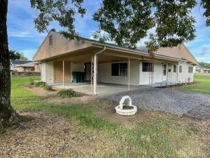 Nice home on a corner lot with spacious living area, updated flooring, and extra large car port with lots of yard space. Separate laundry room, attached storage area, all conveniently on one floor.Easy access to main roads, but still secluded enough to be private. Very close to parks and schools. Lots of windows, exposed beams, and vaulted ceilings.
