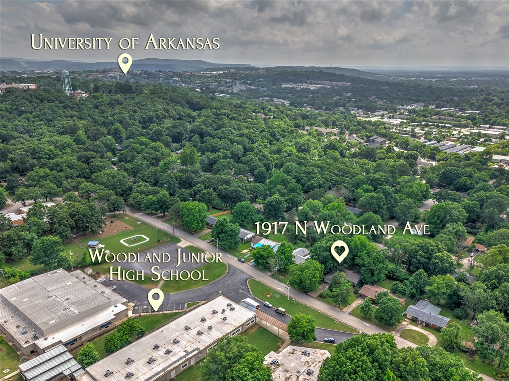 Major opportunity in the heart of Fayetteville. This 3-bedroom, 2-bath home is tucked among mature trees, offering a private, established setting that's hard to find this close to everything. Located just steps from Woodland Junior High and minutes from the University of Arkansas, shopping, dining, parks, and entertainment, the location truly shines. While the home is ready for updates, it presents an excellent opportunity for buyers looking to renovate, invest, or create their dream home in one of Fayetteville's most convenient locations.