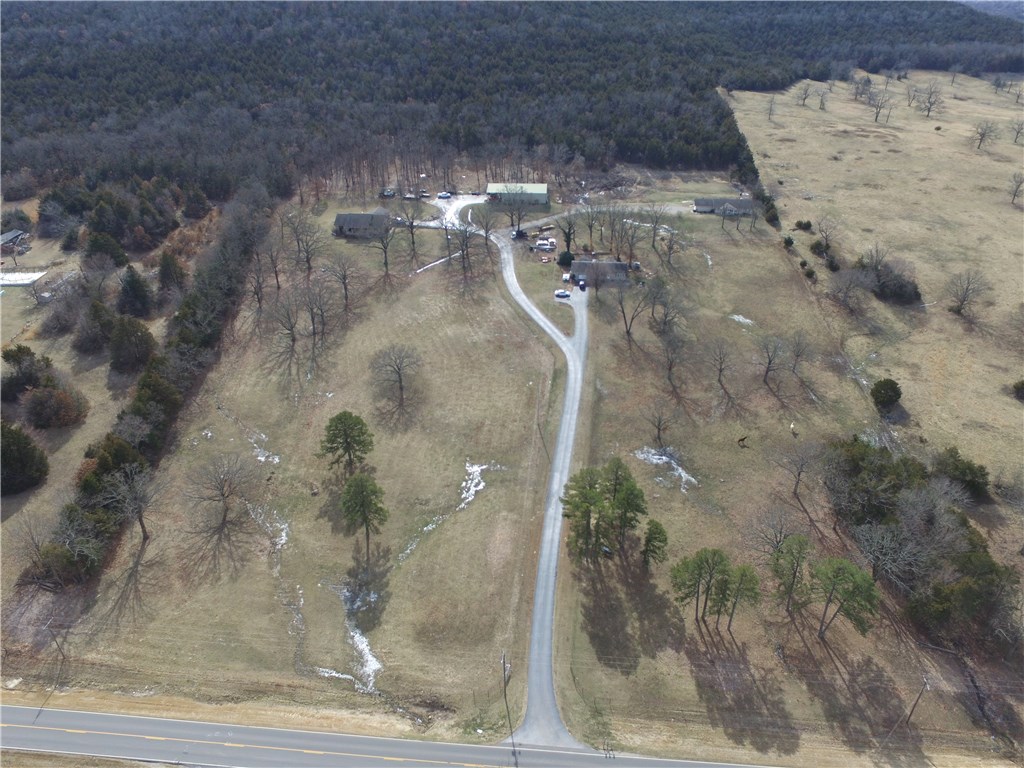 Very nice property located just outside of Berryville city limits, 20 acres m/l more than 1/2 open in pasture, large trees, fenced for horses,  Custom Home built in 1997 Brick exterior, 3BR,2BA, 2 car garage, Second home built in 2003, 1,440 sq,ft, 2BR, 2BA, 2 car garage, Third home built in 1970 3BR, 1BA, one car garage. 40x60 shop with full bath and office, 40x20 additional under roof, 10x10 storm shelter, paved driveway, great views from the front porch.  Shown by appointment.
