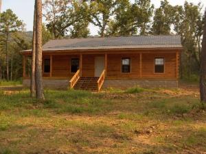 Back on the market! Just a few bits of paint, three small rooms of carpeting and this home is move in ready! Cozy log cabin sided home on the edge of Russellville. Almost 5 acres of nicely laying land, 3 Bed 2 bath with vaulted open kitchen and living, right mix of rustic log/wood and sheetrock. Privacy and quiet living.