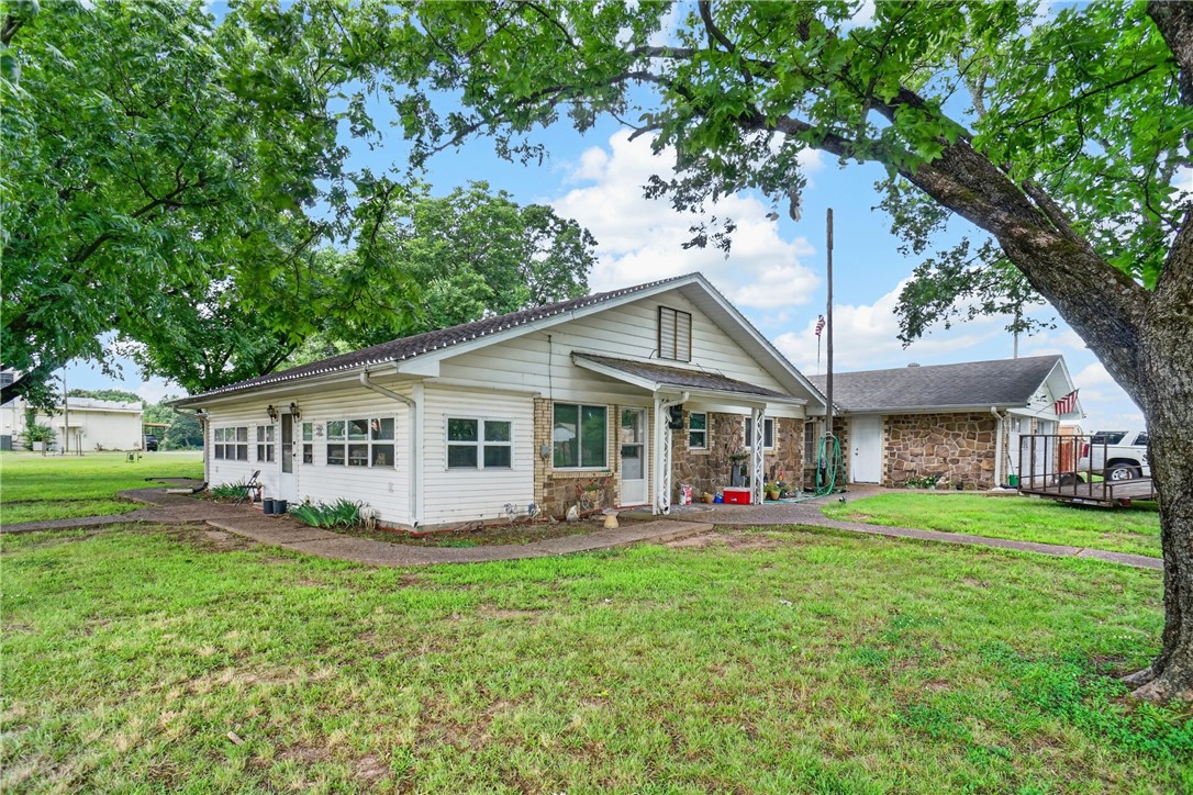 This charming 1,920 square foot rock home offers the perfect blend of comfort and character. Featuring 3 bedrooms and 1.5 bathrooms, the home includes a large living room ideal for family gatherings, a formal dining room perfect for entertaining, and a spacious kitchen with plenty of room for meal preparation and storage. Outside, you'll find a beautiful yard accented by mature pecan trees and a lovely gazebo, creating the perfect setting to relax and enjoy the outdoors. This property is full of warmth and ready to welcome its next owners home.