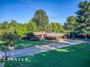 Come by to see this beautiful 3 bedroom, 3 bathroom contemporary home with an inground pool. This home features vaulted ceilings, a gas log fireplace, a large screened in back porch overlooking the inground pool, and a walk-out basement with a family room and a small kitchenette.  This home is in a well established neighborhood nestled on a wooded one acre (m/l) lot on a low traffic street, all while centrally located to the area schools and Historic Downtown Harrison.  Parklike setting with beautifully planted landscaping. Pool is fence enclosed for safety but privately situated on the lot for get togethers and entertaining. Dolphin robot pool cleaner to convey. Storage building, ample storage in carport that could also be a work bench, ample basement storage too! New roof in May 2022.