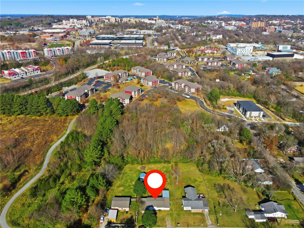 Investor opportunity near the University of Arkansas! 3BR/2BA + bonus room (potential 4th bedroom or second living area), offering flexible layout for rental income. Located on a quiet dead-end street backing to protected greenspace (no rear neighbors) with direct access to Fayetteville’s trail system. Less than 1 mile to campus, Downtown, and major amenities in a strong rental demand area. Features include screened-in porch, two outbuildings with electricity (ideal for storage/workshop), and recent updates including new shower. Value-add potential with room for additional improvements.