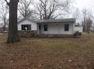 Enjoy this quiet neighborhood with near level lot. Close to the lake with detached 2 car garage with workshop area. Paved Road, large living room, mature trees & much more. www.hudhomestore.com