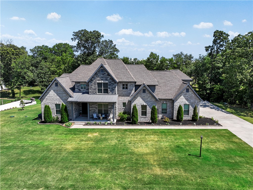 This custom-built home offers unparalleled craftsmanship and quality providing almost every in-home convenience imaginable.  Perfect for entertaining and everyday living, this stunning property features a very large and pretty patio area overlooking a spacious, tree lined backyard.  An acre setting offers lots of privacy and room to enjoy outdoor activities.  This is a must -see for those seeking a beautiful and functional luxury home.  Lots of crown molding, wood wrapped windows hard wood flooring and high ceilings through-out. Storage galore.  Professional photos capture the exquisite details and beauty of this home, highlights its superior craftmanship and luxurious finishes. 

Convenient Location:**
- **Shaw Family Park:** Directly across the street.
- **Willis de Shaw Elementary:** 1.3 miles.
- **Bypass:** 1.8 miles.
- **J.B. Hunt Corporate:** 7.2 miles.
- **Walmart Supercenter:** 3.2 miles.