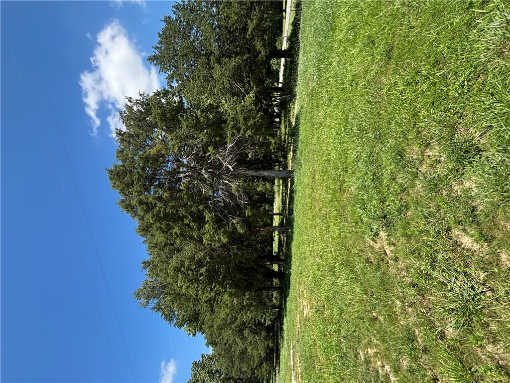 4+/- acres of level land with approximately 450' of HWY 72 frontage.  Over 11,000 cars per day for your high density residential or commercial project. Walmart Super Center being built across the street. Currently zoned residential however, the City of Bentonville is motivated to rezone. Parent parcel is 5.4 acres with building. 4+/- acres to be subdivided.
