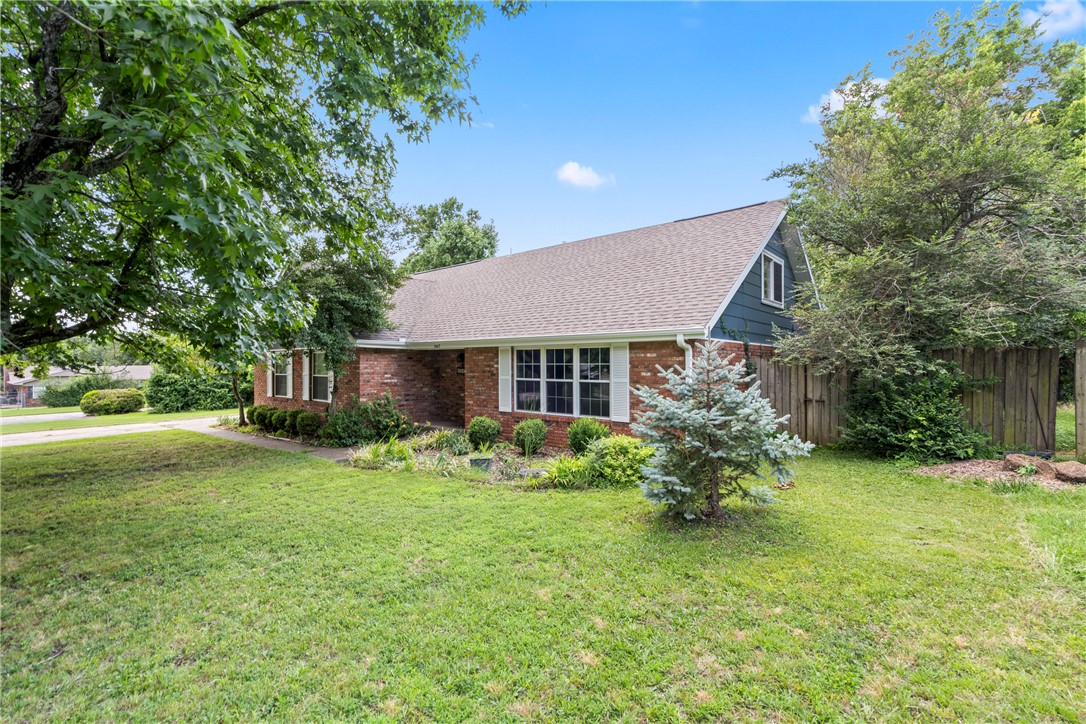 Perfectly maintained and lovingly cared for, this spacious 5-bedroom home is ready to welcome its next owners! Ideally located in the heart of central Fayetteville on a quiet no-through street, you'll enjoy easy access to historic downtown Fayetteville, the University of Arkansas, shopping, dining, parks, and entertainment. The flexible floor plan features the primary suite and a large guest bedroom on the main level—ideal for multi-generational living, guests, or a home office. Multiple living spaces include a welcoming front living room and an oversized den perfect for entertaining, movie nights, or game days. Upstairs offers three additional bedrooms with generous closet space throughout. Relax year-round in the bright solarium overlooking your private backyard oasis with a swimming pool, spa, garden area, chicken coop, storage building, and peaceful wooded backdrop that feels like country living in the middle of town. Don't miss this rare opportunity—schedule your private showing today!