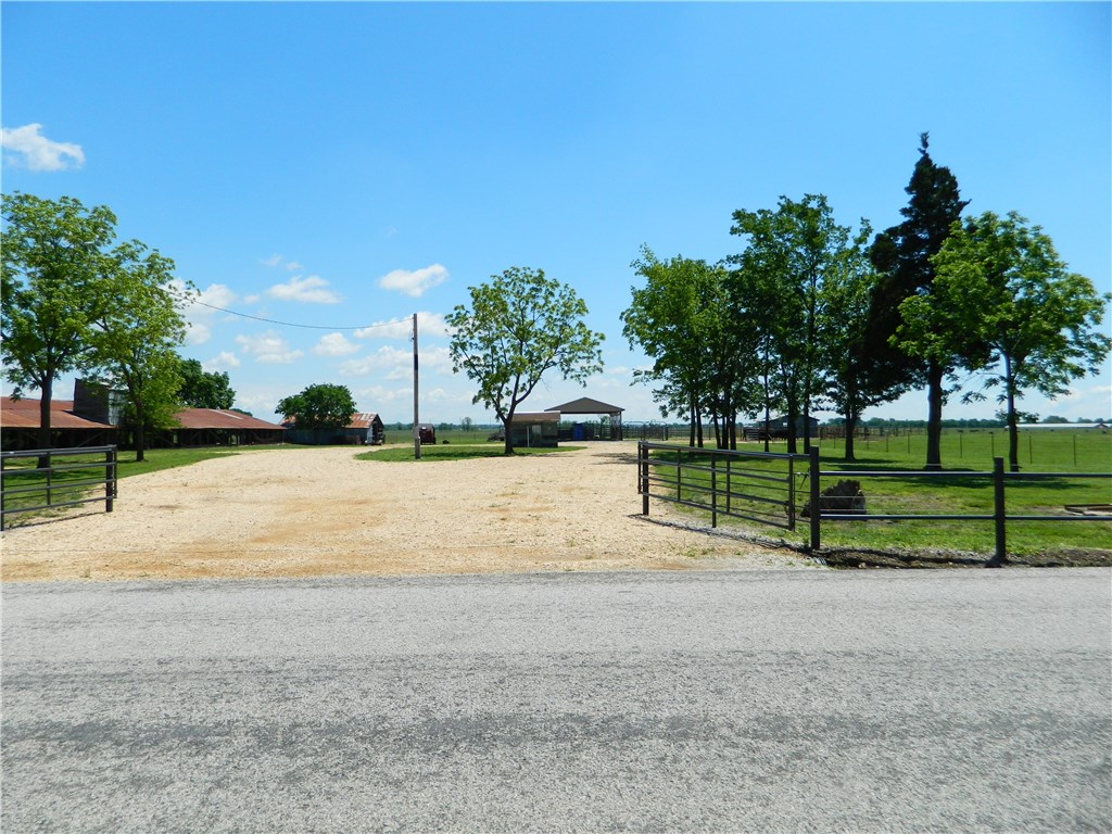 Pristine 155 acre working cattle farm w/2 ponds, 2 wells that have never ran dry with waterlines to 3 Mirafount livestock waterers. Covered new Priefert squeeze chute, PBR rodeo style corrals, panels, and 28 ft adjustable alleyway with slide gates.3 pole barns, hay/equipment storage all on paved county hwy. Electric on site. Rural water at street. Option to purchase cattle. No dwelling, grand views. Listing agent related to seller.