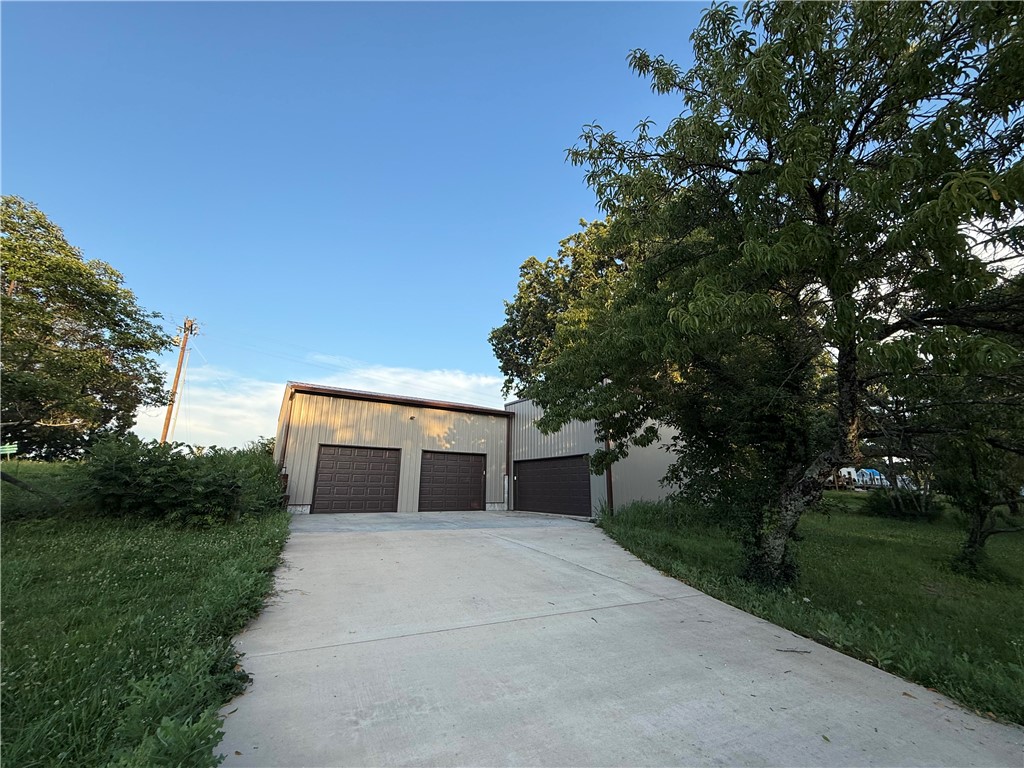 0.95-acre property with two side-by-side garages & direct paved highway frontage near the Kings River. Designed for convenience & versatility, this property provides secure, easily accessible storage for boats, kayaks, canoes, ATVs, UTVs, classic cars, trucks, trailers, equipment & outdoor gear.
For owners of riverfront or rural properties, it offers a practical solution for storing vehicles and equipment without regularly driving low-clearance, luxury, or specialty vehicles on gravel roads. Keep your boat, off-road vehicles, or extra vehicles ready to go, then make the short trip to your river property when needed.
The dual garages offer ample space for storage, workshop use, hobby projects, or equipment staging, while the paved highway location allows for easy access year-round. Whether you're looking for a recreational basecamp, secure storage location, or flexible property with multiple potential uses, this parcel offers convenience, accessibility & proximity to everything the Kings River area has to offer.