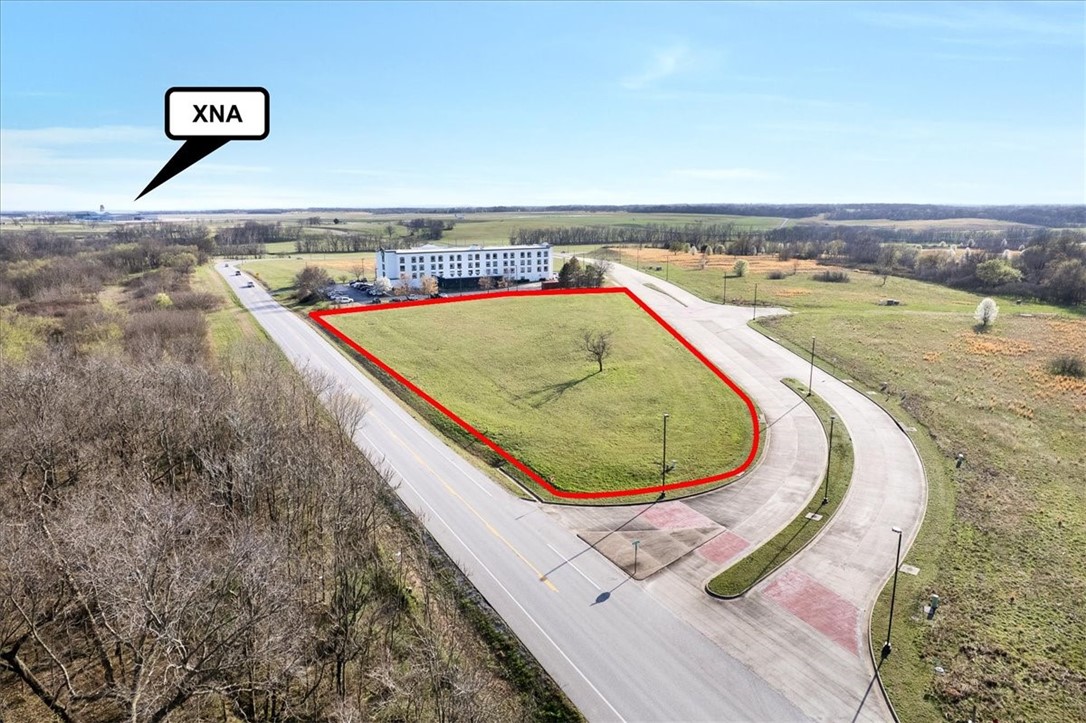 Prime 2.72-acre opportunity in Benton County! Parcel #01-10278-000 is vacant, unimproved land, zoned C-2 in the path of rapid Northwest Arkansas growth. Gas, electric, and water are available at the site, offering a strong head start for development. Located minutes from the XNA airport terminal and next to a major hotel, with excellent visibility, a high-traffic corridor. Traffic counts range from 9,000 to over 30,000 vehicles per day (VPD) depending on the specific section. Ideal for short-term rentals, extended-stay or corporate housing, small multifamily, office, or service-based commercial uses catering to traveler demand. Easy access to Bentonville, Centerton, Rogers, Springdale, and Fayetteville enhances its appeal. Strategic location, strong exposure, and growing demand near XNA make this a compelling investment. Buyer to verify zoning and permitted uses. Drive by today!