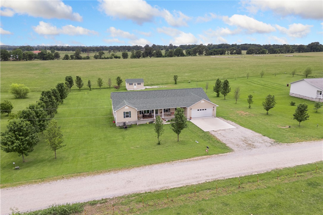 All on one level! This 4-bedroom + an office or 5th bedroom, 3 full bathroom home situated on a flat, usable acre in a peaceful country setting built in 2015 will get you excited about your next home! With 2,712 sq ft, this spacious home offers a highly desirable split floor plan with room for everyone. The oversized primary suite is going to stand out for sure, featuring not 1 but 2 giant walk-in closets and a spa-like bathroom! The open layout provides comfortable living and entertaining space throughout the home. Step outside to enjoy the brand-new covered back deck, perfect for relaxing, grilling, or taking in the views. The property also includes a storage building and plenty of outdoor space for hobbies, gardening, or simply enjoying the country lifestyle. Conveniently located less than a 1/2 mile off a well-maintained gravel road, this home offers the best of both worlds — peaceful country living while still being just 15 minutes to groceries, shopping, and the hospital.