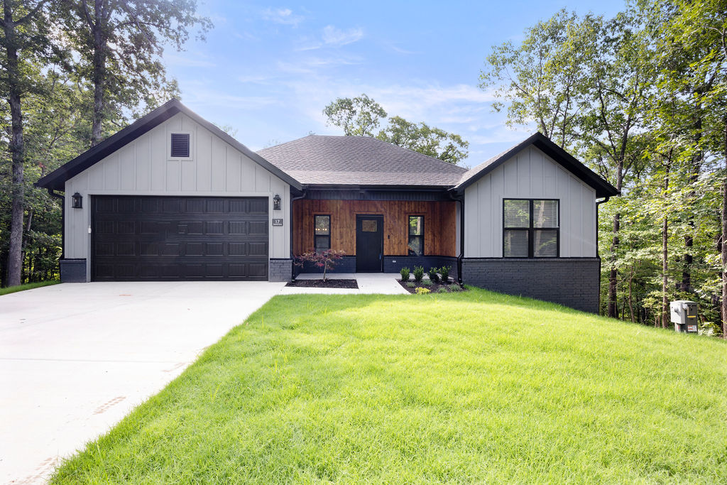 *Agent Owned*  New Construction with refrigerator, gutters, and blinds INCLUDED. Completed the first week of July and now ready for move-in! Northeast Bella Vista location on a .43 acre wooded lot in Bentonville Schools, and backing up to "Flo Ride" - Part of The Back 40 Trail System - Nearly 40 miles of trails designed and built for mountain biking but also open to use by pedestrians! Extended covered deck overlooking mature trees and beautiful views. Interior features vaulted living room ceilings, modern electric fireplace, and a light colored luxury vinyl plank flooring throughout. Large kitchen island with extra storage, white quartz counters, and stainless steel appliances. Master bath has fully tiled shower and dual vanities. Dedicated laundry room with built-ins. Hot water recirculation system. One year builders warranty. See photos and MLS attachments for plans and survey.