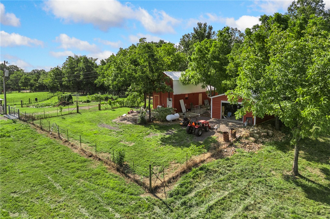 Escape to the Ozarks with this unique 38.99-acre turn-key hobby farm offering income potential, breathtaking views, and endless possibilities. The property features a charming 1BR/1BA cottage with an eat-in kitchen, propane cooktop, on-demand hot water, mini-split HVAC, and walk-in shower. Approximately 60% of the acreage is open pasture with the balance wooded, providing excellent privacy, wildlife habitat, and recreation opportunities. Improvements include a 36'x40' barn under construction with a 16'x40' loft designed for future living quarters, 20'x30' metal shop with concrete floor and roll-up door, root cellar, sheep barn, chicken pens, orchard, large garden, hay field, cross-fencing creating 3 separate pastures, and 2 ponds. Orchard includes peach, apple, plum, pear, muscadine, and walnut. Approximately 220' of Hwy 27 frontage serves a 6-8 acre hay field that could offer future RV park potential. Fiber internet and rural water are available. Located just 14 miles from a Buffalo River access point.