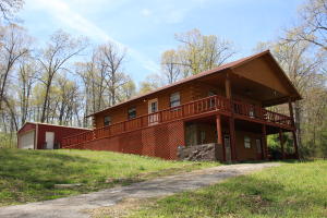 Beautiful 3 bed, 2.5 bath log home on 25 wooded acres tucked into a hill, minutes from town and the White River. Featuring a 3/4 wrap around deck, second kitchen in walk-out lower level, trails throughout and 2 streams. Large upstairs living area with real hardwood floors and luxury vinyl planks on lower level. Clean garage/shop and a chicken coop complete the property. Recent updates include: all exterior and deck stained/sealed, new flooring on lower level and upstairs kitchen, HVAC.