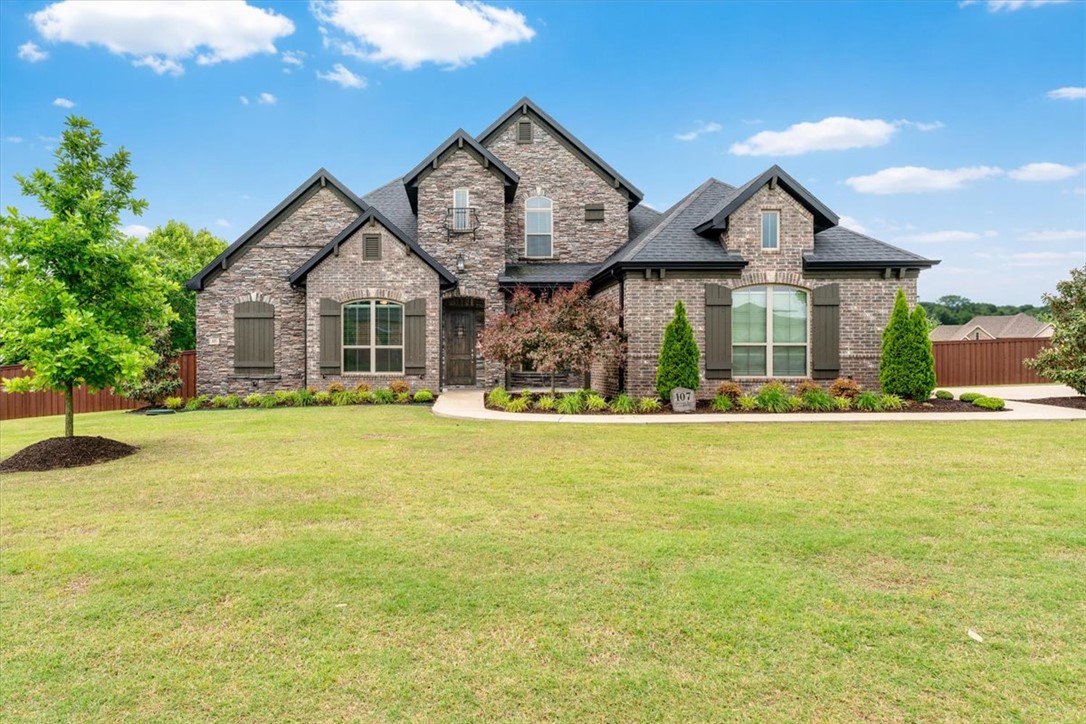 Luxury living meets everyday comfort at 107 Torrance Dr in Cave Springs. Located in one of Northwest Arkansas’ most desirable and coveted subdivisions, Otter Creek,  this beautiful home offers spacious living, upscale finishes, and an incredible backyard retreat. The open-concept layout is perfect for entertaining, with generous living spaces, abundant natural light, and a seamless flow throughout. The kitchen opens to the main living area, creating a warm and inviting atmosphere for gatherings large or small. Step outside to your private oasis featuring a stunning in-ground pool, and outdoor living space with fireplace that is ideal for entertaining guests, or relaxing and peaceful evenings at home. The backyard offers both privacy and functionality with plenty of space to enjoy outdoor living. Conveniently located near top-rated schools, shopping, dining, Pinnacle Hills and easy access to the I-49 corridor, this home combines luxury, comfort, and convenience in one exceptional package.