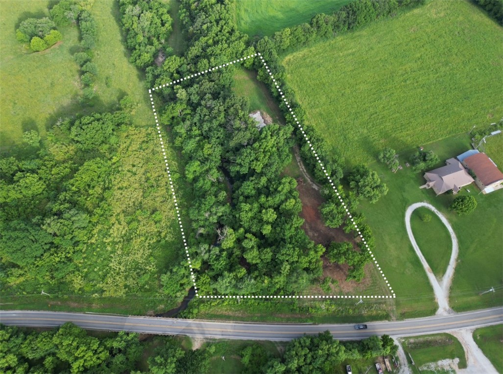 Beautiful 2.45-acre property offering privacy, natural beauty, and building-ready improvements. Situated on a paved road and surrounded by mature trees, this property features a year-round creek running along the edge for a peaceful and scenic setting. Existing slab with plumbing already installed provides an excellent foundation for your future home or getaway. Septic system and well are already in place, saving time and expense as you build.