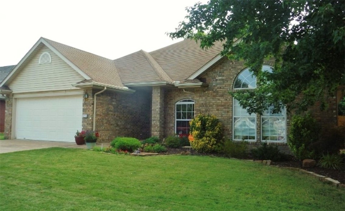 Welcome home to this move-in ready 4-bedroom, 2-bath gem nestled in an established, quiet neighborhood in Rogers, AR. Thoughtfully updated throughout, this 1,876 sq. ft. split-bedroom floor plan offers comfort, style, and functionality for today's buyer.
The spacious living room makes a stunning first impression with its stone fireplace, soaring 10' ceilings, and elegant crown molding. The open-concept kitchen and dining area is a chef's delight, featuring granite countertops, rich hardwood floors, custom tile backsplash, and a center island/breakfast bar — all flowing seamlessly to the outdoor living space.