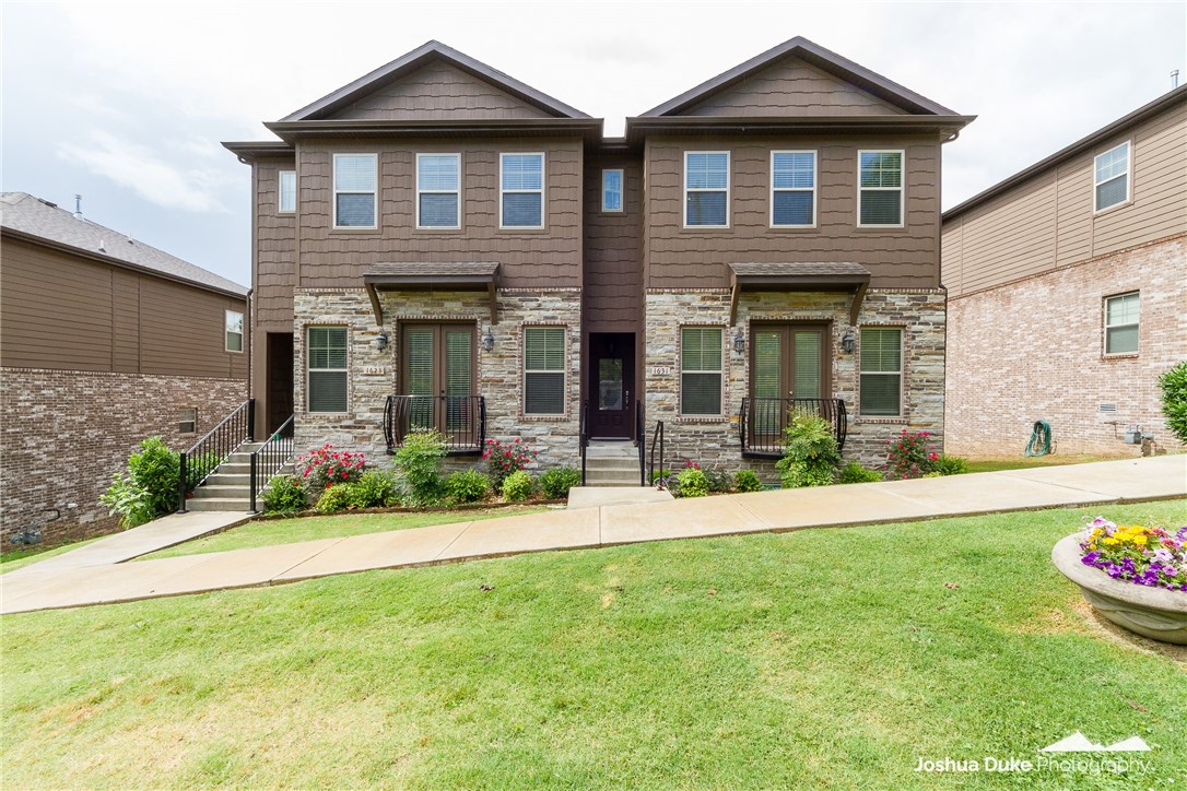 Two year old Brownstone style townhome situated on treed lot. GREAT LOCATION- close to I-49, U of A and within walking distance to Bud Walton Arena and Razorback Stadium. Amenities include hardwood floors, crown molding, granite countertops and stainless appliances including a gas range. It is pre-wired for security system and sound. Upgrades includes custom cabinets and bookshelves surrounding a ventless gas fireplace in living room and a Container Store garage organizing system that conveys with the property.